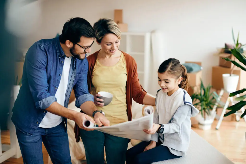 An group of 3 people from a family looking at a map.