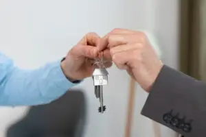 Keys being held by real estate agent and buyer