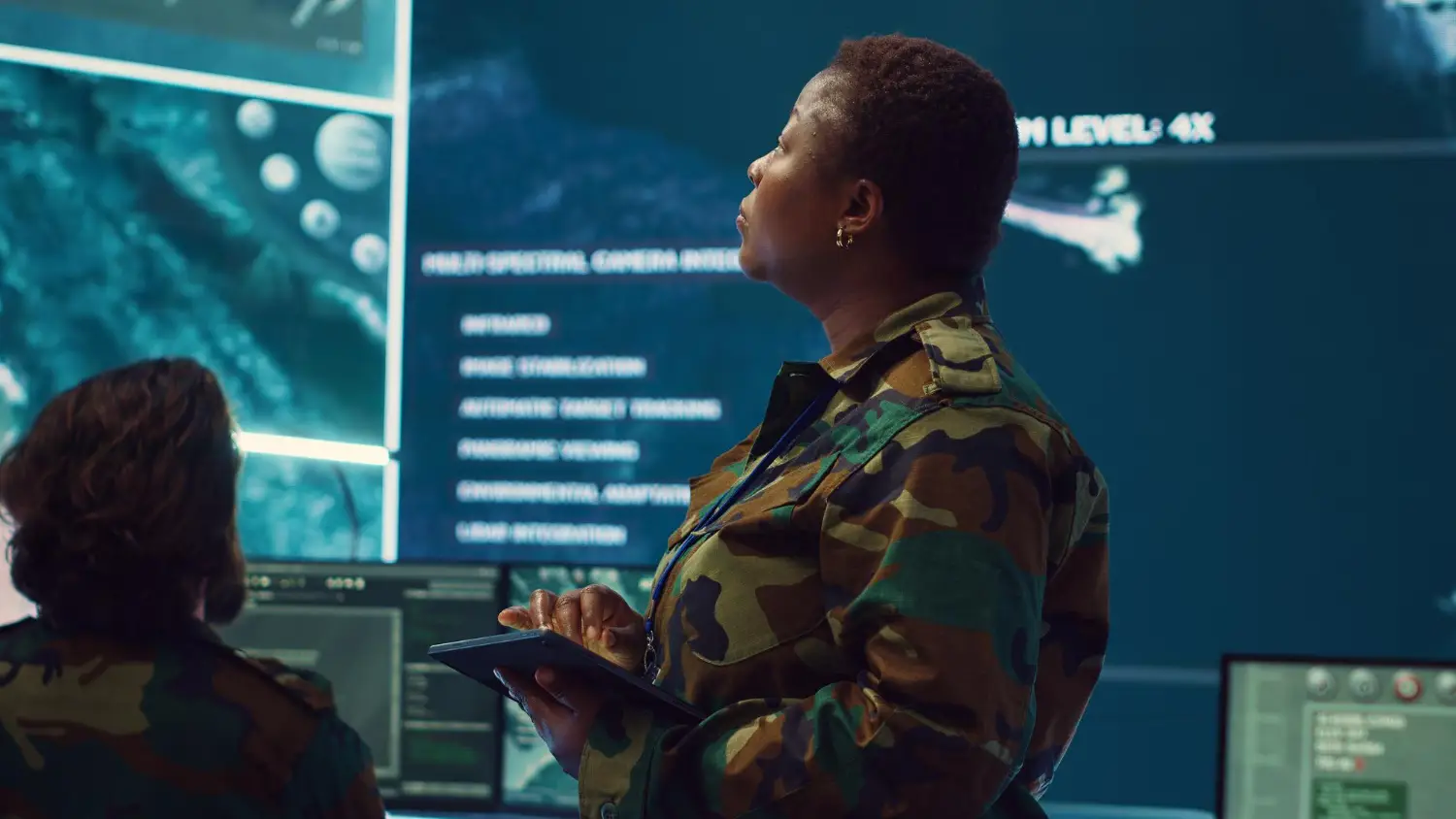 Woman high tech specialist studying satellite cctv visualization on a big screen